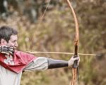 man using bow and arrow
