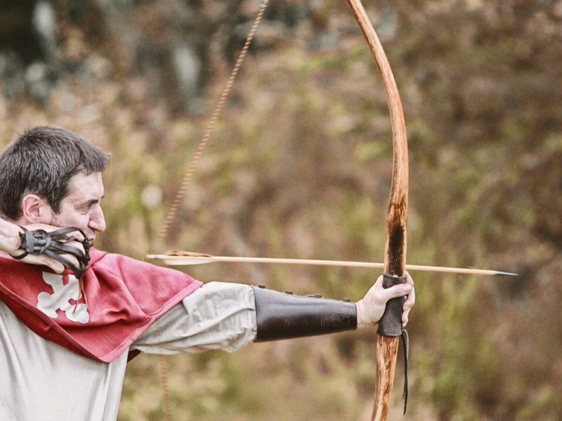 man using bow and arrow