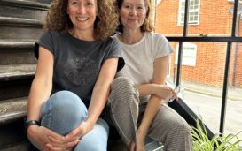 Sandie and Cathy sitting next to each other on stairs in lime tree workshop sevenoaks