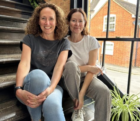 Sandie and Cathy sitting next to each other on stairs in lime tree workshop sevenoaks